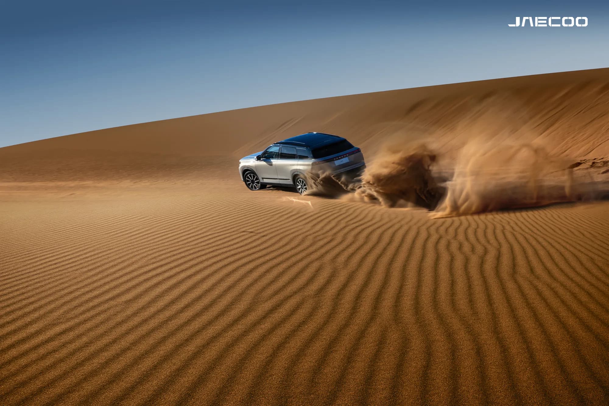 JAECOO SUV driving through a desert landscape