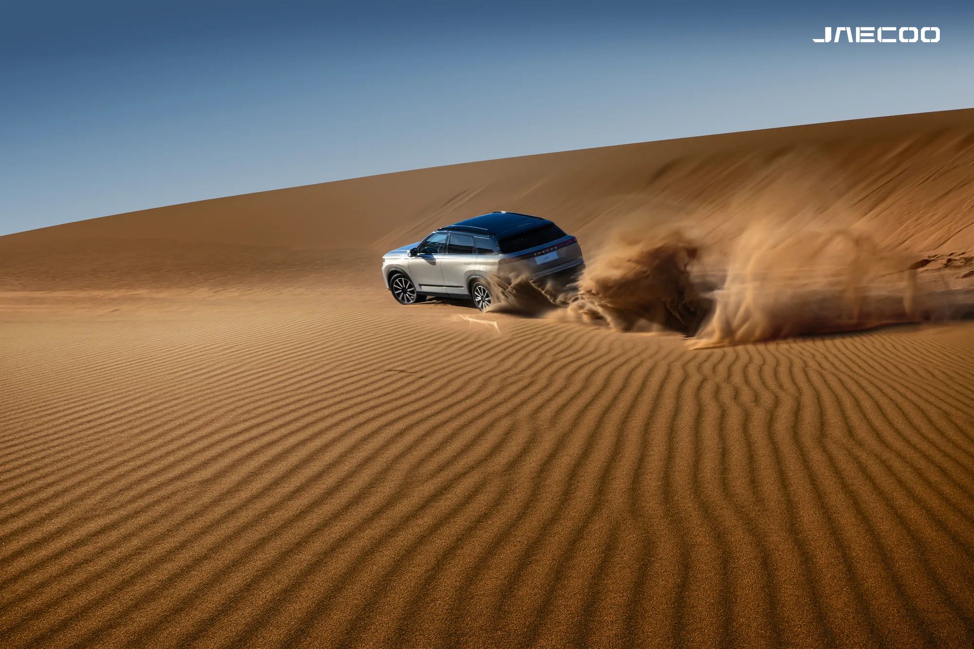 JAECOO SUV driving through a desert landscape